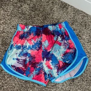 Nike dry-fit athletic shorts, size Small, multicolor splatter design, blue trim